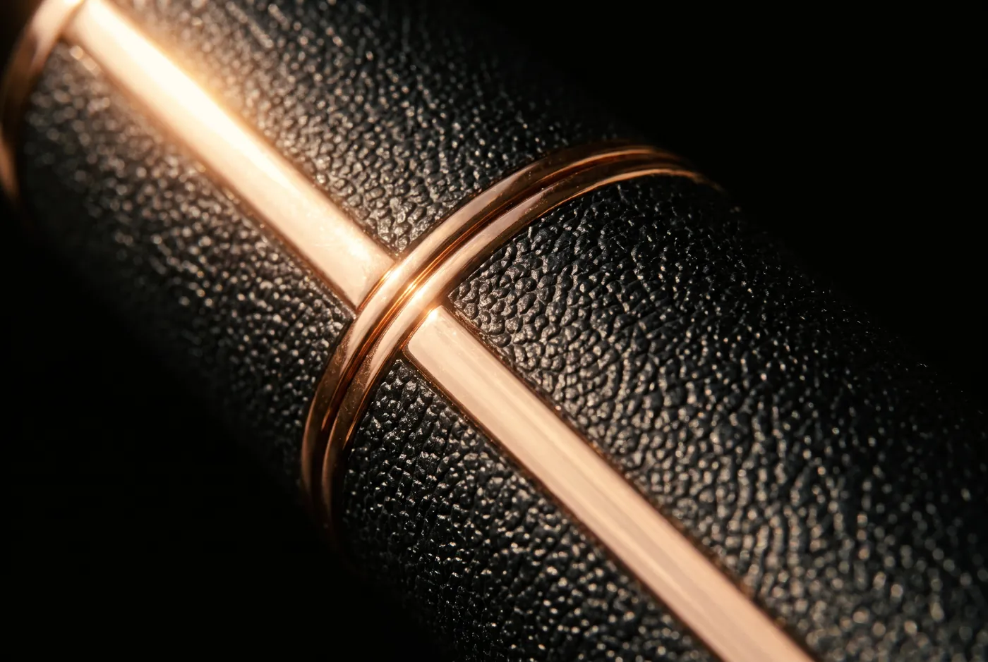 Macro detail of the black vegan leather and rose gold of the CADANUM atomizer